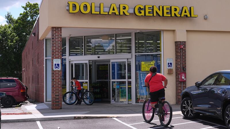 FILE - Children ride their bicycles to the Dollar General store, Aug. 21, 2025, in Nashua, N.H.