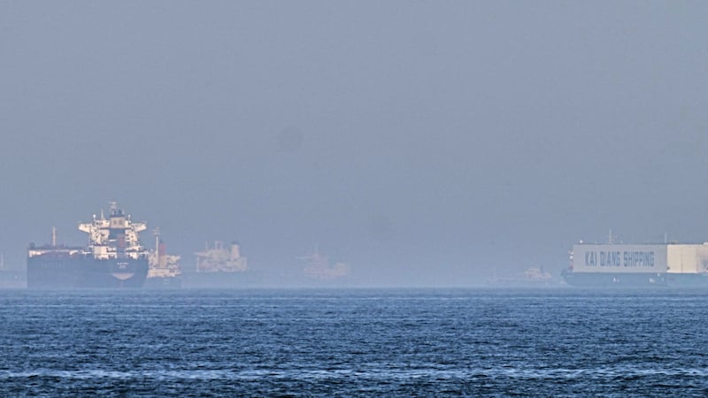 A tanker, left, and a car carrier are anchored at sea in the Gulf of Oman near the Strait of...