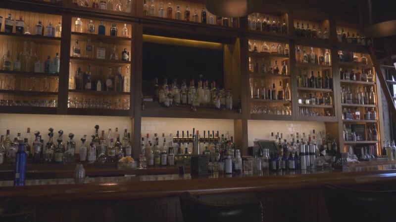 Bottles on display behind a bar on Charlottesville's Downtown Mall.