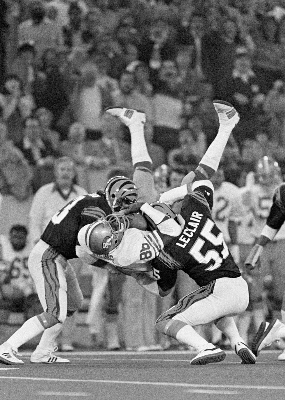 FILE - San Francisco 49ers tight end Charle Young (86) holds on to a Joe Montana pass as he is...