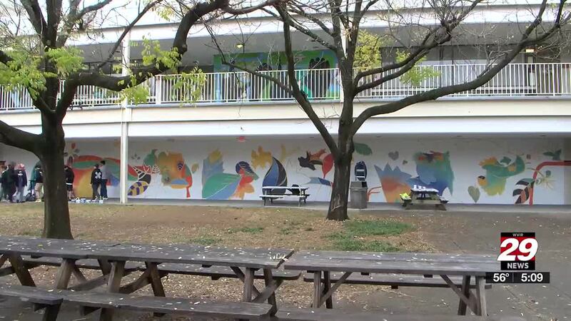 Charlottesville High School students are painting a 90-foot-wide mural to make their courtyard...